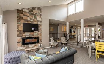 Campbell Reserve Resident Clubhouse with a couch and a fireplace